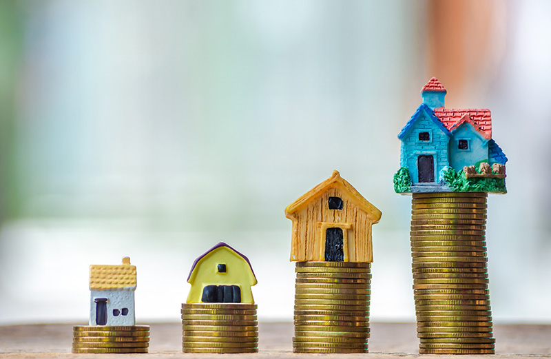 Model houses on top of coins